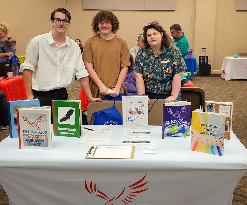 Students and staff at the Edison School table at a community event