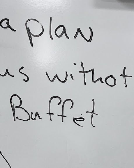 A classroom whiteboard showing the quote of the day with a word misspelled